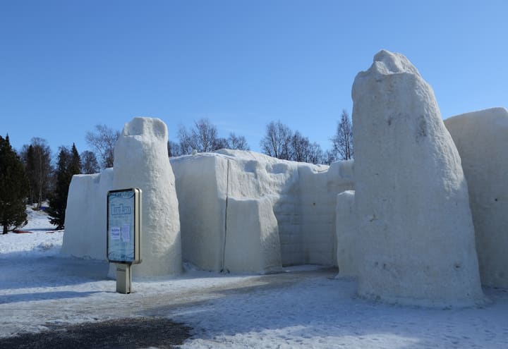 Snow towers and walls of the Kemi SnowCastle under a clear late-winter sky